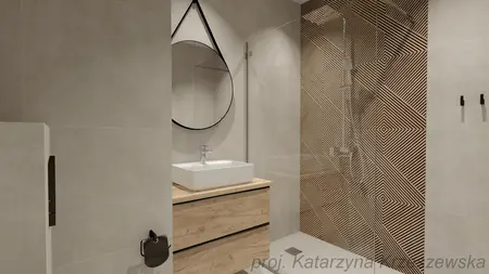 Wnętrze łazienki z drewnianą szafką, okrągłym lustrem oraz nowoczesnymi detalami w stylu industrialnym, minimalistycznym i współczesnym.