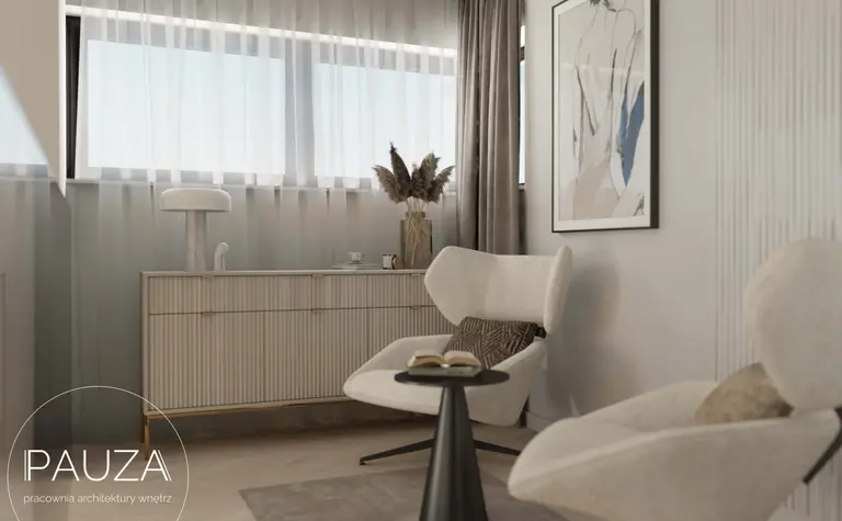 Nowoczesne wnętrze salonu z jasnymi fotelami, minimalistyczną szafką oraz dużymi oknami.