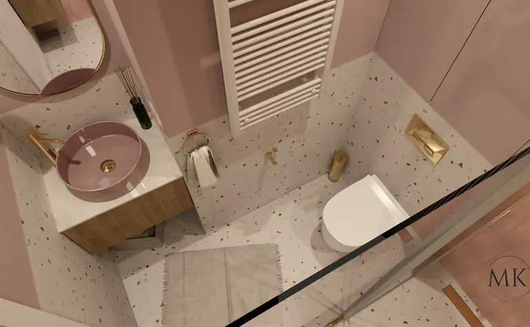 Nowoczesna łazienka z różową umywalką, złotymi detalami i eleganckim wykończeniem.