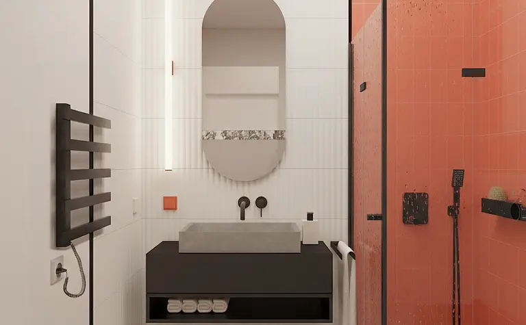 Wnętrze łazienki z czarną umywalką, pomarańczowymi płytkami i nowoczesnym wykończeniem.