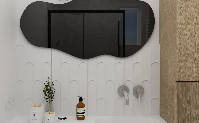 Nowoczesna łazienka z białą umywalką, czarnym lustrem oraz drewnianymi akcentami.