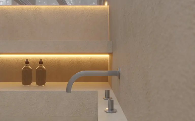 Wnętrze łazienki z podświetlaną umywalką w stylu soft minimalizm.