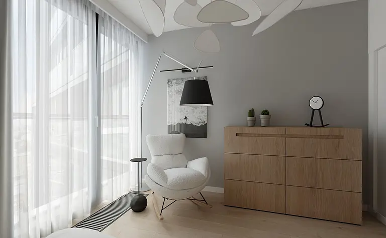 Styl minimalistyczny wnętrza z białym fotelem i drewnianą komodą.