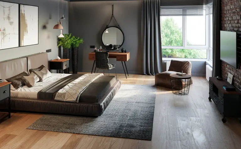 Wnętrze sypialni w stylu industrialnym i soft minimalizm z szarymi ścianami i drewnianą podłogą