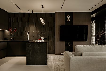 Wnętrze kuchni w minimalistycznym stylu z czarnymi i szarymi elementami.