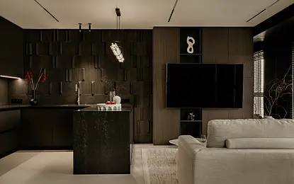 Wnętrze kuchni w minimalistycznym stylu z czarnymi i szarymi elementami.