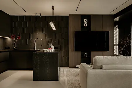 Wnętrze kuchni w minimalistycznym stylu z czarnymi i szarymi elementami.