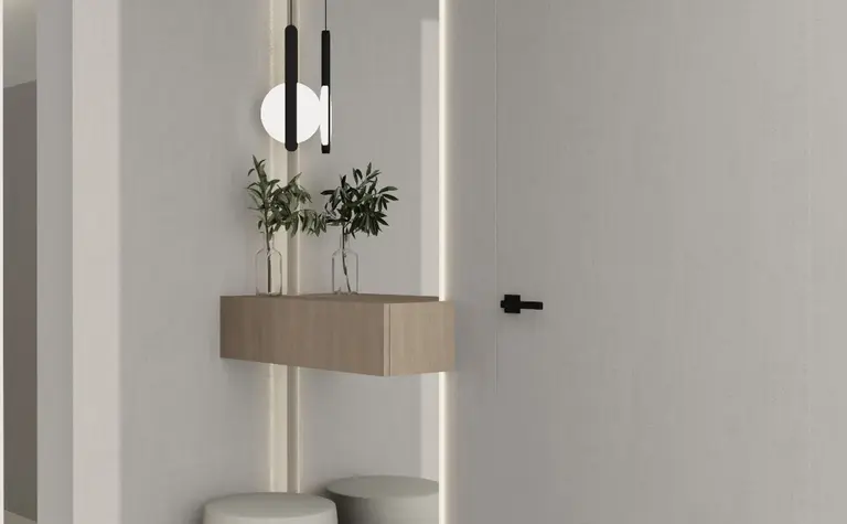 Nowoczesny przedpokój z minimalistycznym oświetleniem i roślinami w szkle.