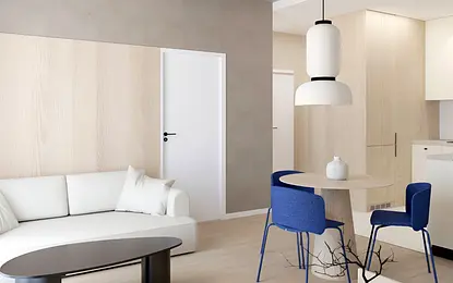 Wnętrze w stylu japandi z jasnym drewnem, minimalistycznymi meblami i niebieskimi akcentami.