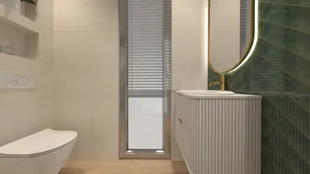 Wnętrze nowoczesnej łazienki z białą umywalką i zieloną płytką.