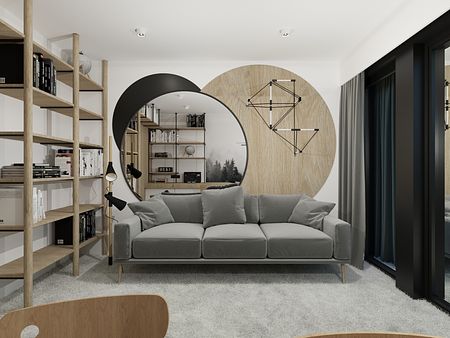 Wnętrze współczesnego salonu z szarym kompletem mebli i drewnianymi akcentami.