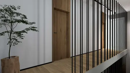 Korytarz z drewnianą podłogą, rośliną i stalowymi balustradami w nowoczesnym wnętrzu.