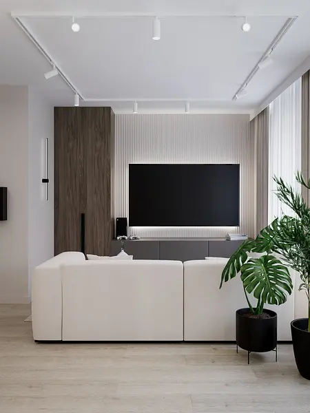 Wnętrze salonu w minimalistycznym stylu z białą sofą i roślinnością.