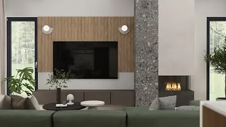 Wnętrze salonu z zieloną kanapą, drewnianymi detalami i industrialnym kominkiem.