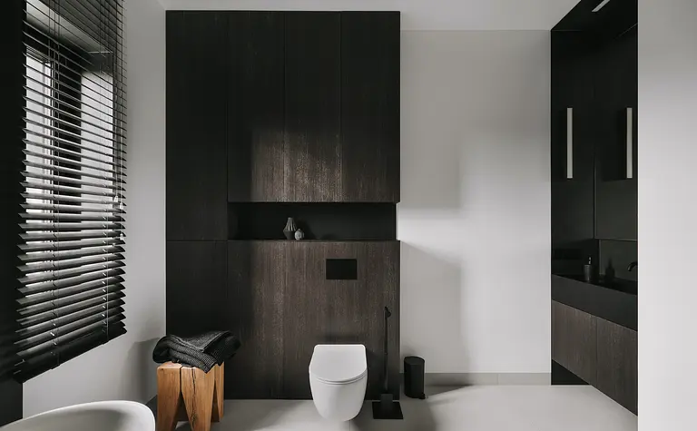 Nowoczesna łazienka z ciemnymi meblami i minimalistycznymi detalami, styl industrialny i skandynawski.