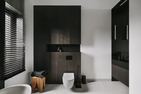 Nowoczesna łazienka z ciemnymi meblami i minimalistycznymi detalami, styl industrialny i skandynawski.