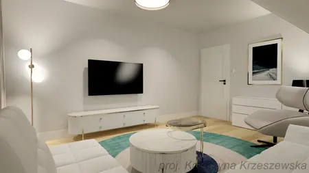 Wnętrze salonu z białą sofą, telewizorem i minimalistycznym wystrojem.