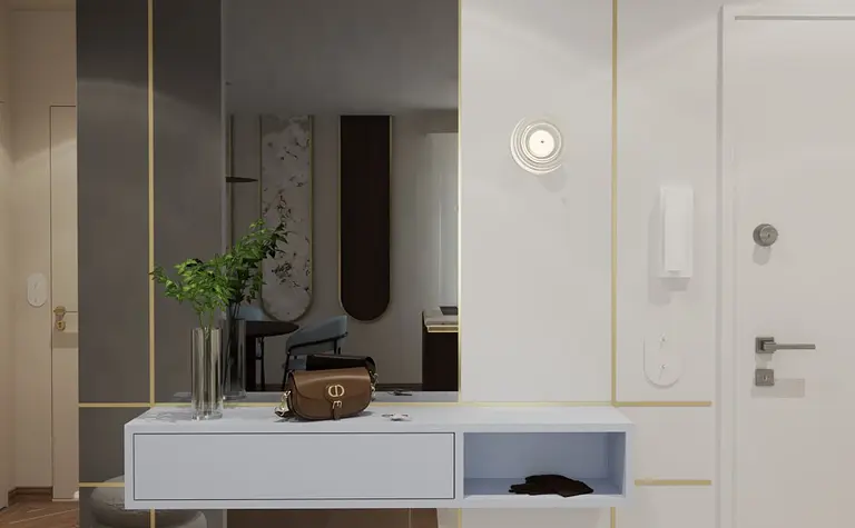 Nowoczesny przedpokój z lustrzaną ścianą, stołem i rośliną.