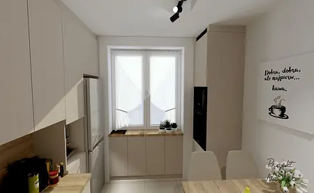 Kuchnia z jasnymi meblami, drewnianym blatem i roślinami.