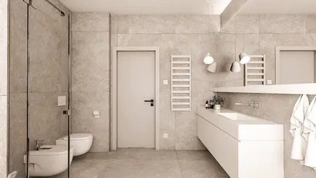 Nowoczesna łazienka z szarymi płytkami i białą armaturą, minimalistyczny design.