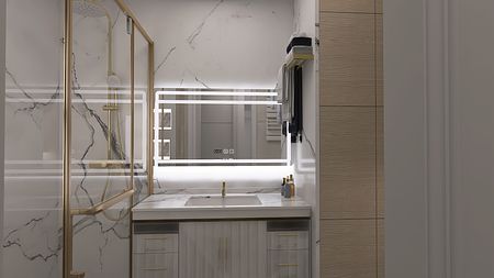 Nowoczesna łazienka z marmurowymi płytkami i złotymi dodatkami.