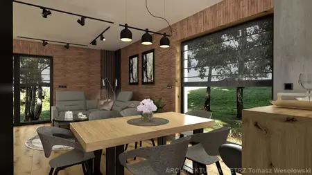 Wnętrze salonu w stylu industrialnym z drewnianym stołem, szarymi fotelami i ceglaną ścianą.