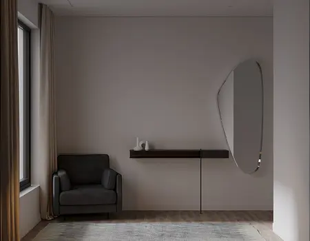 Minimalistyczne wnętrze z szarym fotelem i lustrzaną półką