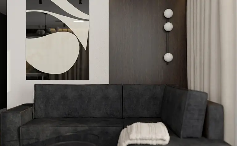 Wnętrze salonu w stylu quiet luxury i współczesnym z ciemną sofą i drewnianymi akcentami.
