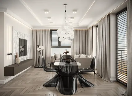 Nowoczesne wnętrze salonu z czarnym stołem, beżową sofą i eleganckim oświetleniem.