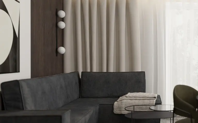 Wnętrze salonu w stylu quiet luxury, współczesne z ciemną sofą i drewnianymi detalami.