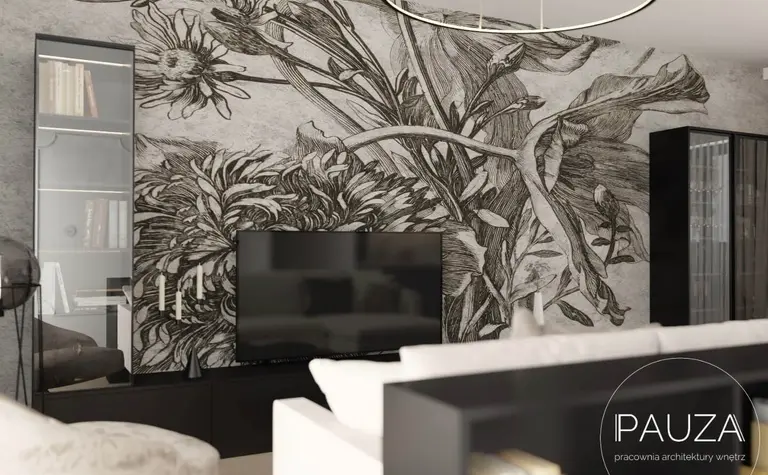 Nowoczesny salon z telewizorem i muralem roślinnym na ścianie.