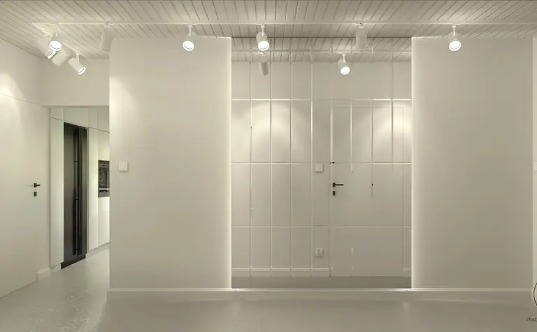 Minimalistyczne wnętrze z białymi ścianami i czarnymi akcentami.