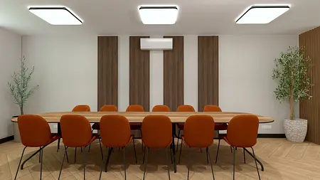 Wnętrze nowoczesnej sali konferencyjnej z drewnianym stołem i pomarańczowymi krzesłami.