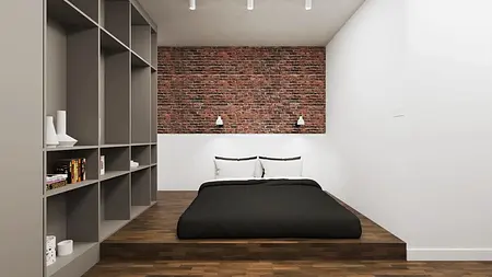 Wnętrze sypialni z ceglaną ścianą, drewnianą podłogą, industrialne i vintage akcenty.