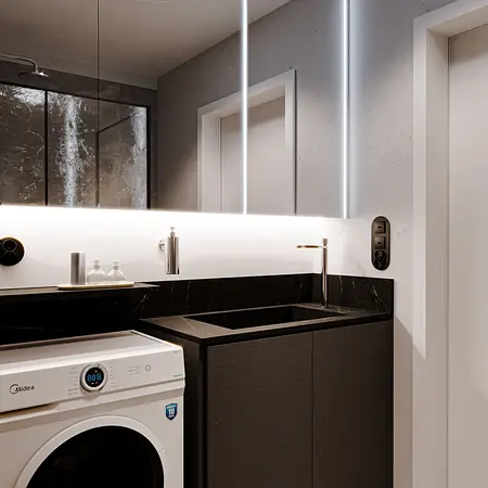Nowoczesna łazienka z pralką, czarnym blatem i minimalistycznym stylem.