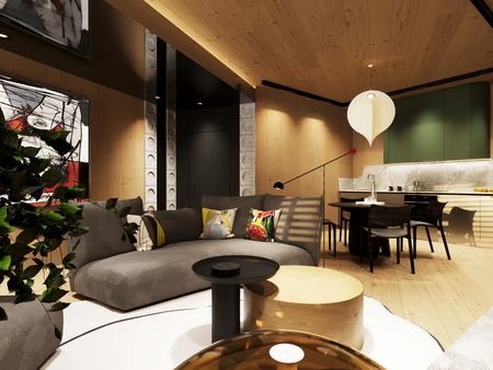 Wnętrze salonu z szarym narożnikiem, eklektycznymi akcentami i zieloną kuchnią w stylu dopamine decor.