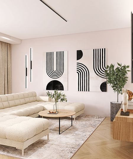 Nowoczesny salon z jasną sofą, obrazami i rośliną