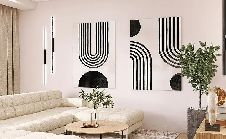 Nowoczesny salon z jasną sofą, obrazami i rośliną