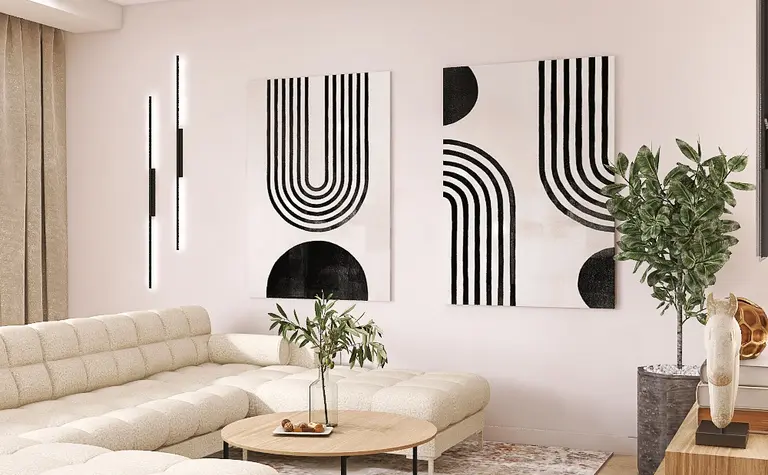 Nowoczesny salon z jasną sofą, obrazami i rośliną
