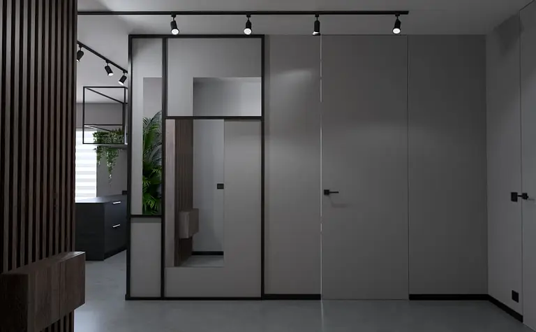 Przedpokój w stylu industrialnym i minimalistycznym z szarymi ścianami i nowoczesnymi detalami.
