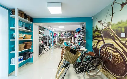 Garaż z rowerami, akcesoriami i niebieskimi ścianami w stylu boho.