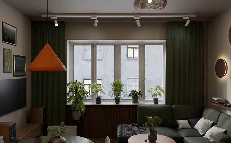 Wnętrze salonu eklektycznego z zieloną sofą i pomarańczowym lampionem.