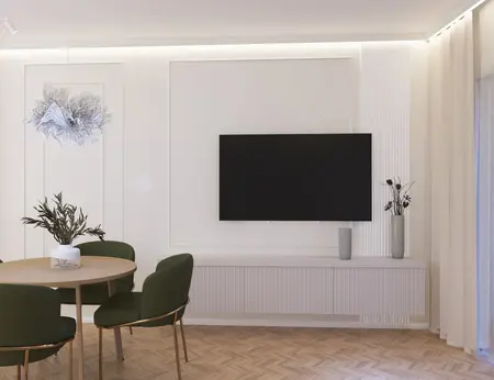 Wnętrze jadalni z zielonymi krzesłami, okrągłym stołem i nowoczesnym oświetleniem.