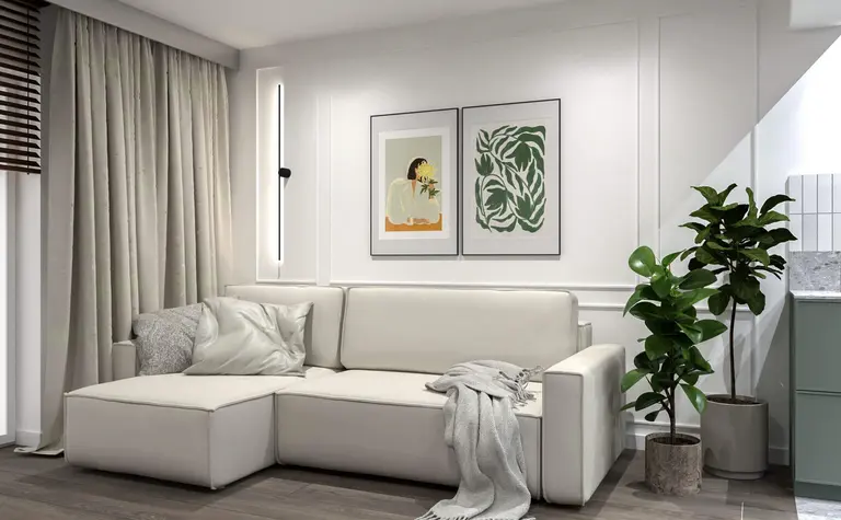 Wnętrze salonu z białą sofą, zielonymi roślinami i minimalistycznymi detalami.