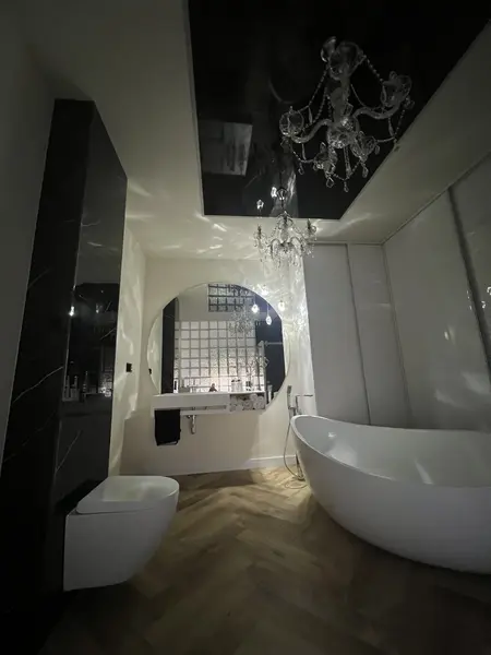 Luksusowa łazienka glamour z białą wanną i eleganckim oświetleniem.