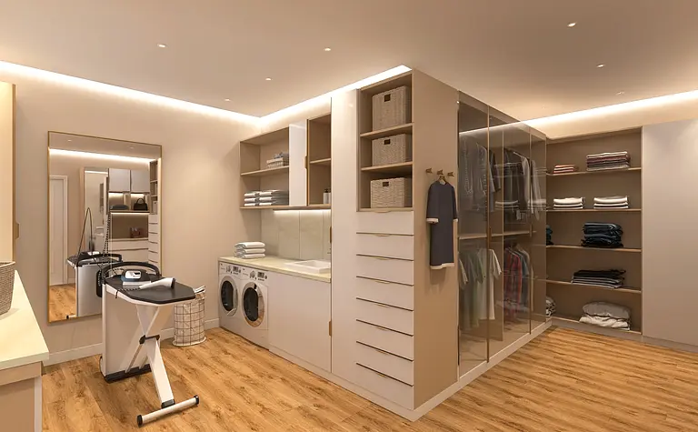 Wnętrze garderoby z białymi meblami, drewnianą podłogą i nowoczesnym oświetleniem.