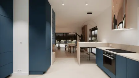 Wnętrze kuchni w stylu minimalistycznym z niebieskimi meblami i jasnym blatem.