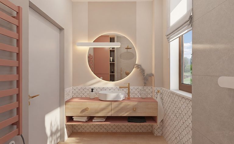 Wnętrze łazienki z różowym blatem, okrągłym lustrem i nowoczesnymi akcentami.