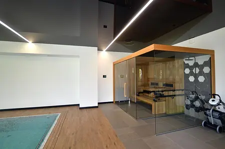 Wnętrze nowoczesnej sauny z drewnianymi elementami i minimalistycznym designem.