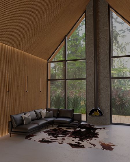 Wnętrze salonu w stylu industrialnym z dużymi oknami i skórzanym kompletem mebli.